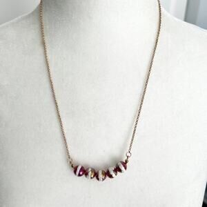 Unique red and white iridescent faceted beaded necklace on a gold tone chain